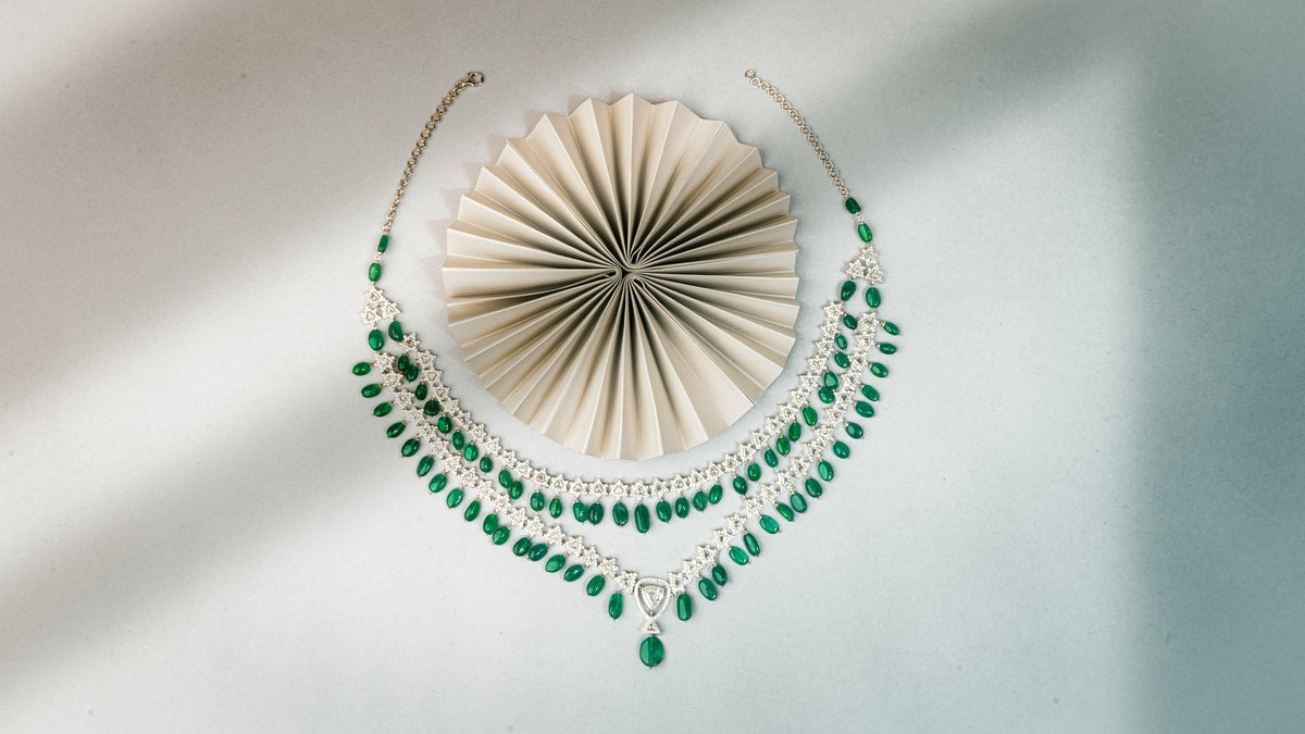 Green necklace artfully placed on a white board